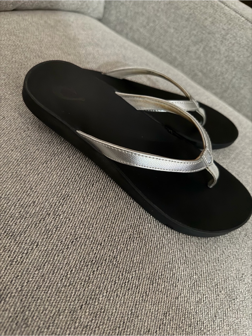 OluKai Women's Black Footbed with Silver Straps Flip Flop
